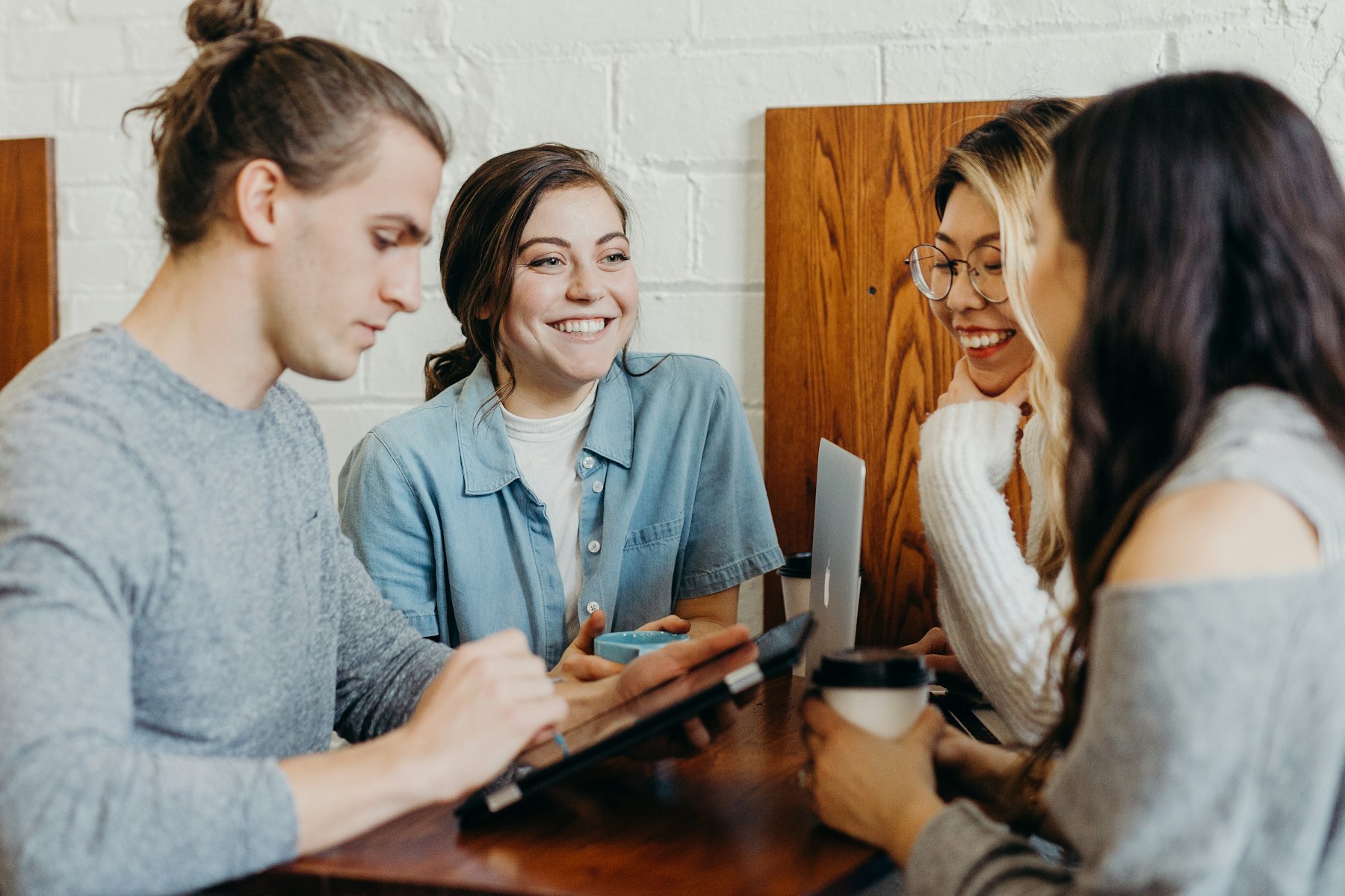 A small group of people talking together around a table